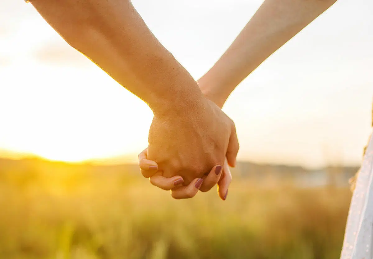Couple holding hands together